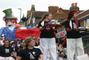 The procession in Uckfield Carnival with people on stilts