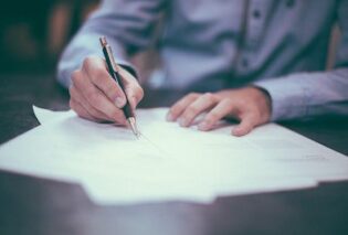 Photo of a man filling in a form or survey